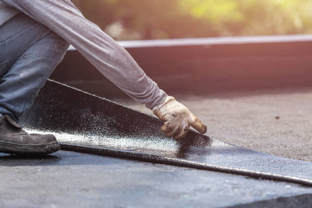 Professional Basement Waterproofing technician working in Beach, ND